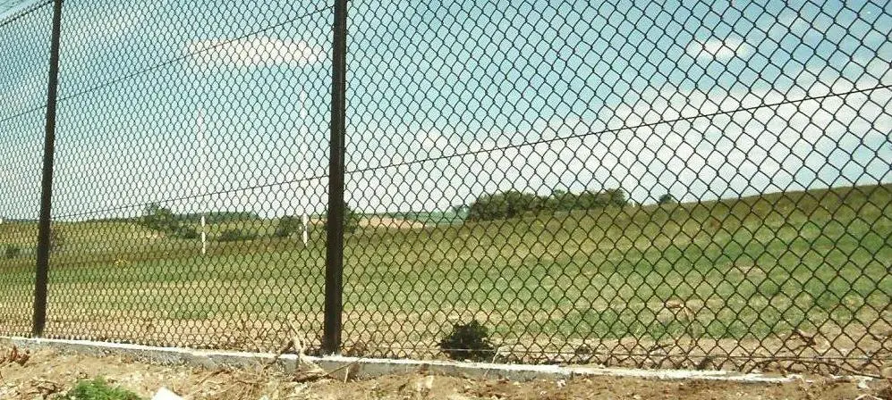 Diamond-pattern GI chain-link fencing (compound jali) installed as a boundary